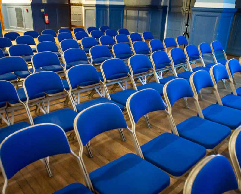 Chairs in a conference room that are all empty.